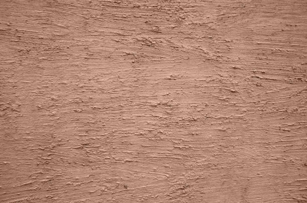 textured plaster made on a pistachio-colored wall. Color 2025 Mocha Mousse. High quality photo