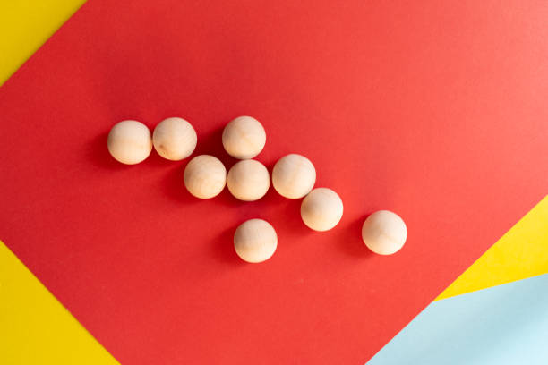 istock Wooden ball on a red background 2189138516