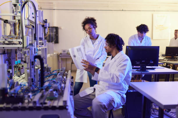 istock African American scientists reading plans in robotics lab. 2189138650
