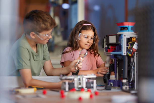 istock School kids working on his science project in laboratory. 2189138981
