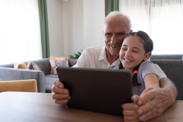 istock Grandfather and granddaughter using tablet 2189139325