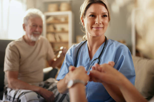 istock Smiling female nurse supporting her senior patient at home. 2189139422
