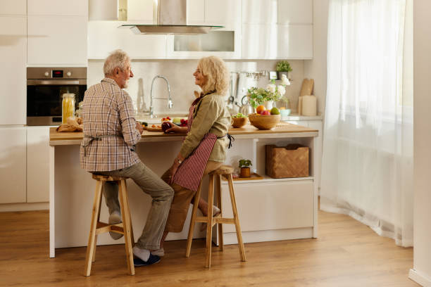 istock Happy mature couple enjoying in conversation at the kitchen. 2189139710
