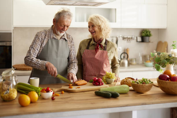 istock Happy senior couple preparing food in the kitchen. 2189140880