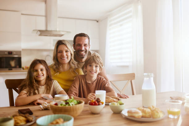 istock Happy family enjoying in meal at dining table. 2189141359