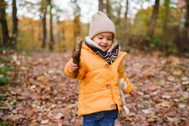 istock A little girl is playing in the forest 2189144814