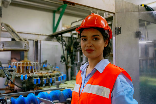 Employee is working at beverage factory. Technology and beverage production factory.