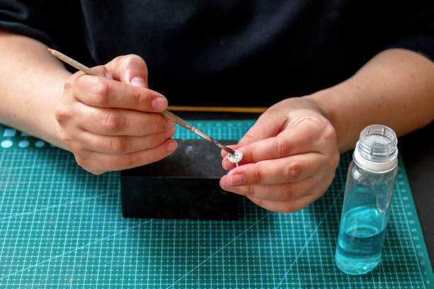 istock Woman crafting handmade silver ring in workshop. Ring making process in jewelry workplace. 2189147684