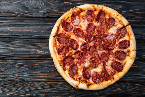 istock Pizza pepperoni fast food . Top view on rustic background 2189148628