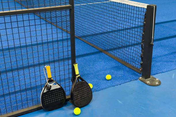 istock padel racket on a padel blue court with a ball 2189150621