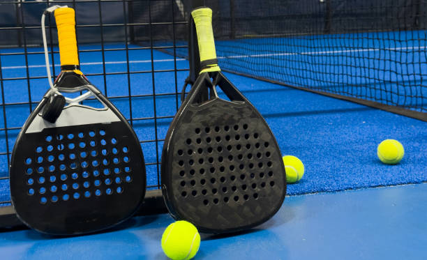 istock padel racket on a padel blue court with a ball 2189151030