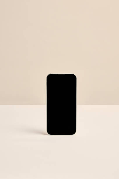 istock Minimalist smartphone standing against beige background. Perfect for showcasing mobile interfaces, branding, or promotional content. 2189151786
