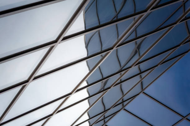 reflection with distortion in the window of a modern building color blue abstract urban background