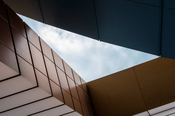 istock blue sky with clouds between the walls of a modern office building 2189152764