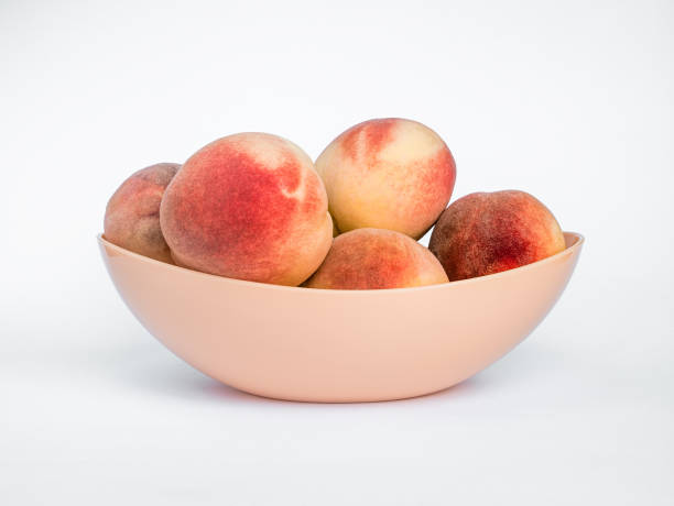 istock White Swan Peaches in a Plastic Vase Isolated on White Background 2189155650