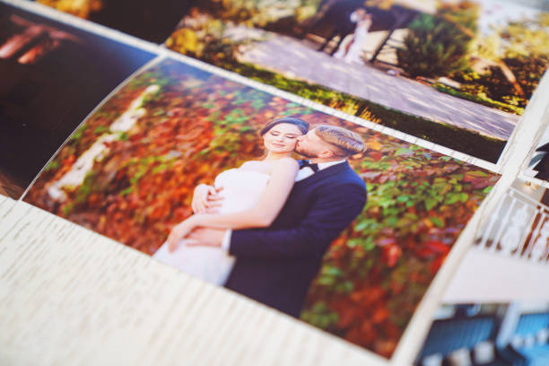istock Printed wedding photos laid out on a wooden surface. 2189155792