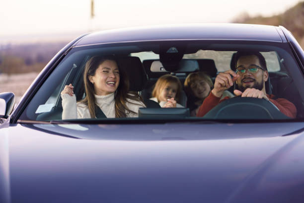 istock A happy family sings while traveling by car 2189155883