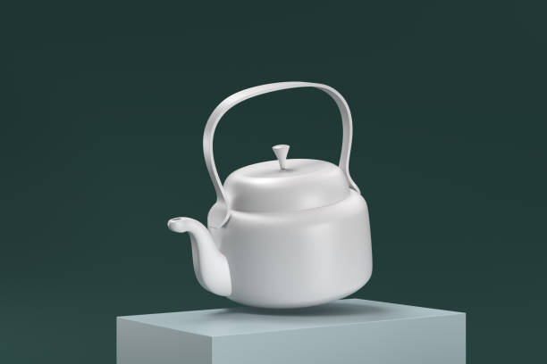 istock A white teapot is sitting on a green surface 2189156387