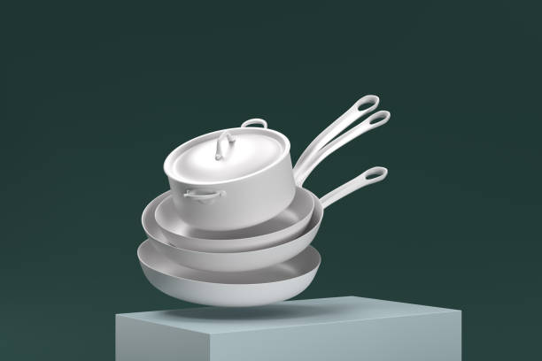 A stack of white pans on top of a green box. The pans are arranged in a way that they appear to be falling off the box