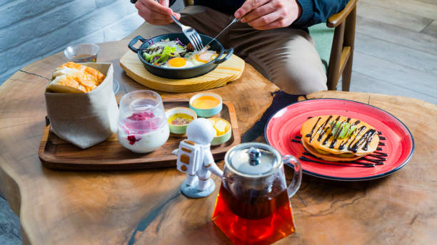 istock Delicious breakfast with fresh ingredients and tea at a cozy cafe table 2189157518