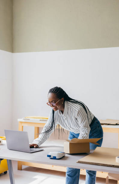 Woman Preparing Package for Online Shopping Order in Modern Workspace