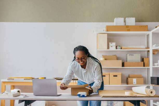 istock Successful Woman Entrepreneur Packaging Products in Home Office Setup 2189159982