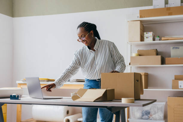 istock Entrepreneur Working in Office with Packaging and Laptop 2189159996