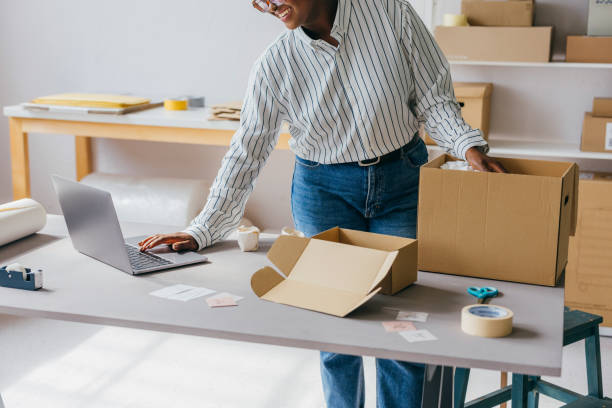 istock Entrepreneur Packing Products for Shipment in A Modern Workspace 2189159997
