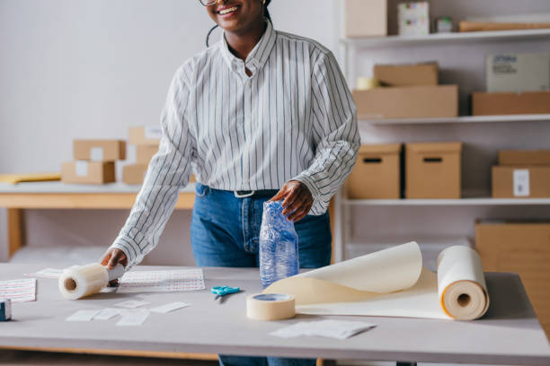 istock Entrepreneur Packing Orders in Small Business Workspace with Packaging Supplies 2189160060