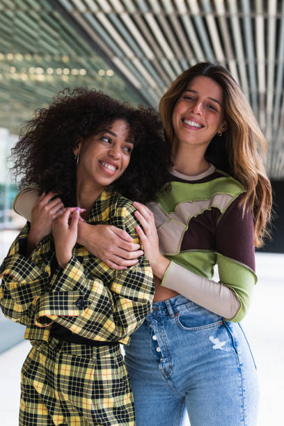 istock Content diverse female friends embracing in city 2189160304