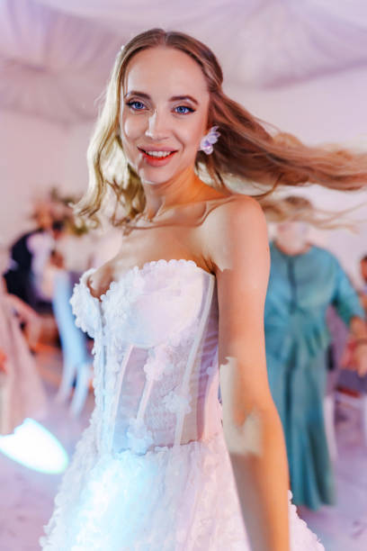 istock Happy bride with long blonde hair dancing. 2189165459