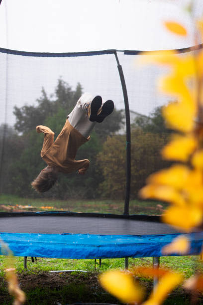 istock Young boy performing backflip on trampoline in autumn 2189167723