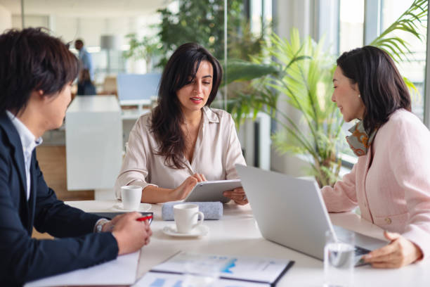 istock Multiracial Team Engaged in Business Discussion with Technology 2189170731