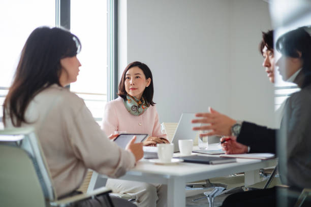 istock Focused Asian Business Team Collaborating in Office Meeting 2189170755