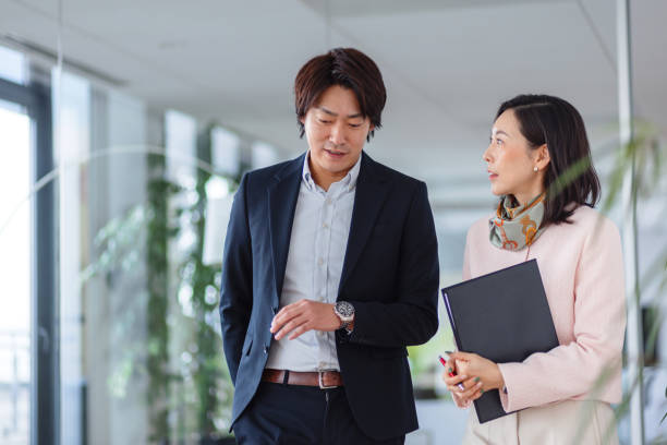 istock Asian Business Professionals Engaged in Office Discussion 2189170876