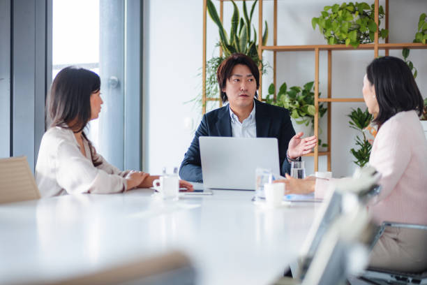 istock Asian Businesspeople in a Meeting 2189170968
