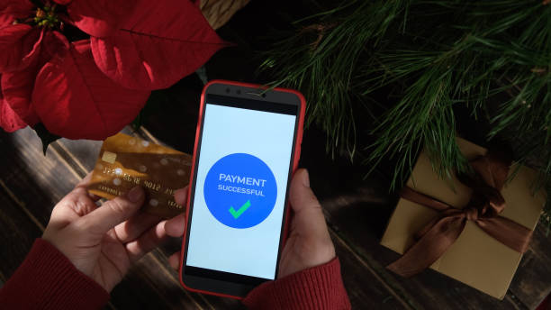 istock Paying online for Christmas shopping using smartphone and payment card. 2189171084