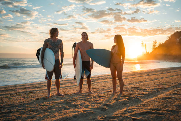 istock Caucasian Friends Joyfully Surfing on Gold Coast Beach 2189171851