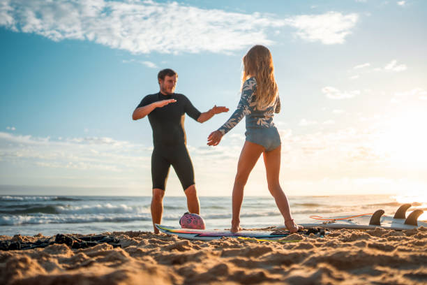 istock Caucasian Father Joyfully Teaching Surfer Techniques on Sunrise Beach 2189171895