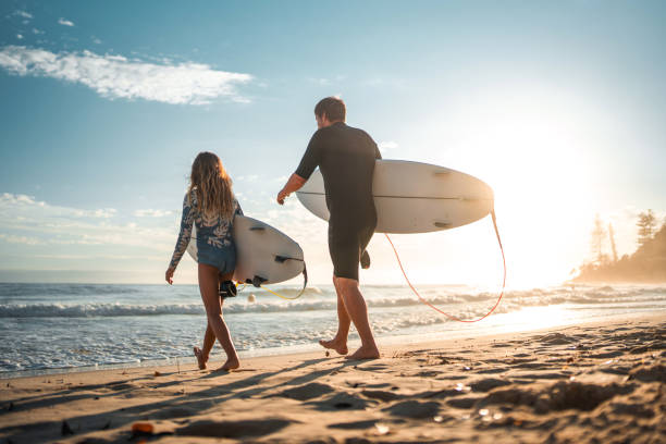 istock Caucasian Father and Daughter Joyfully Surfing at Sunrise 2189171900