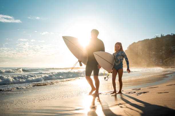 istock Cheerful Caucasian Father and Daughter Strolling on Sunrise Beach 2189171902
