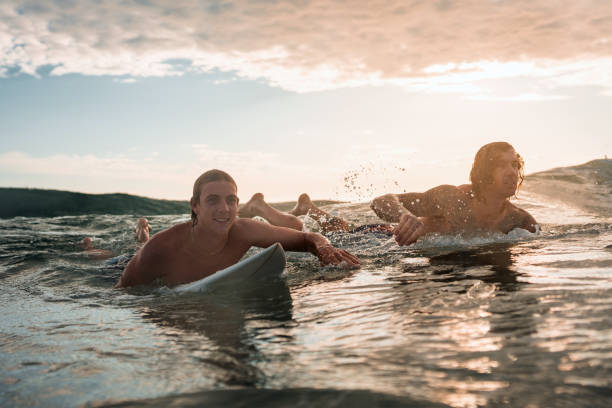 istock Joyful Caucasian Male Surfers Conquer Sunrise Waves 2189171927