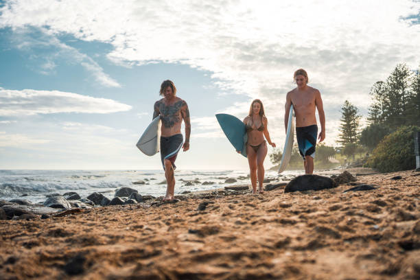 istock Joyful Caucasian Surfers Strolling Along Sunrise Beach 2189171961