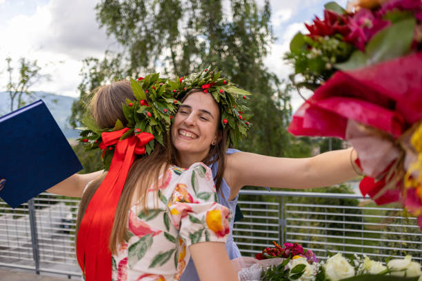 istock Embracing Friends with Bouquets and Laurel Wreaths 2189172074