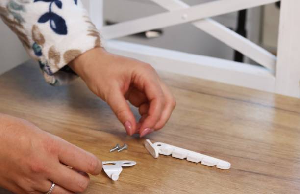 istock A woman is examining a window latch. Close-up. 2189172440