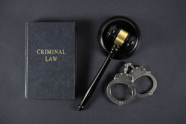 istock Law book, judge's gavel and handcuffs on gray textured table 2189172763