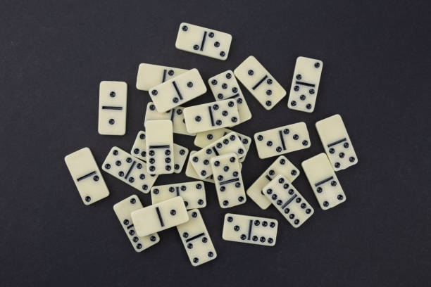 istock pile of white domino stones dark background 2189173025