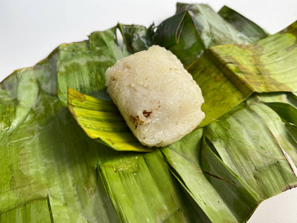 istock Lemper, is a snack made from glutinous rice, filled with chicken, meat or fish floss, wrapped in banana leaf 2189174108