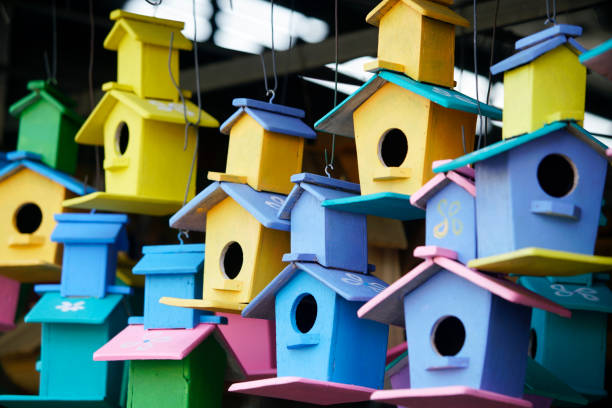 istock Colorful Birdhouses Hanging Outdoors in a Charming Display 2189177182