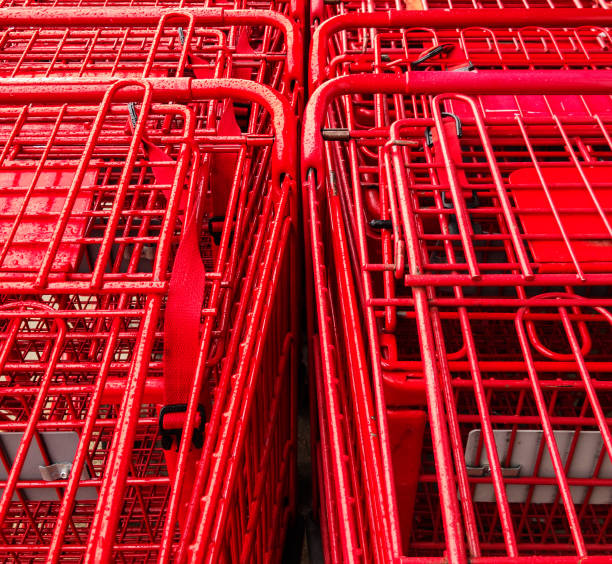 Close-up of stacked red shopping carts covered wth rain drops.